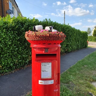 Sheep Knitted sheep on a postbox