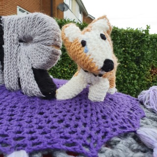Knitted memorial to Elizabeth II, close up showing corgi tear